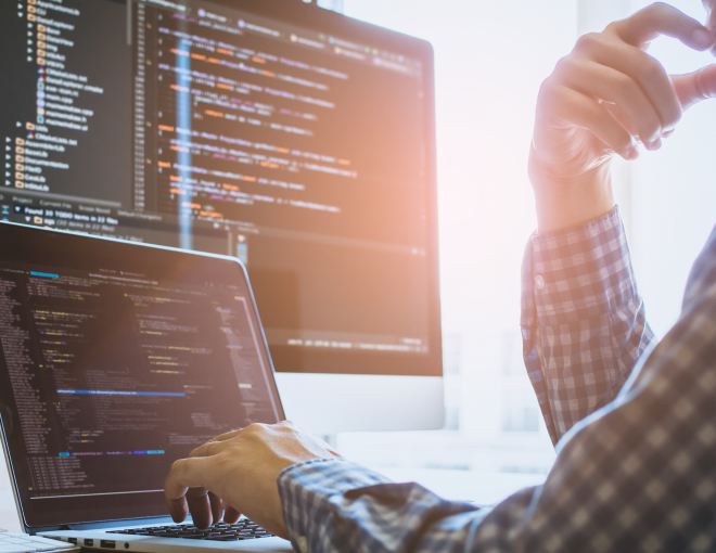 Person analyzing code on computer